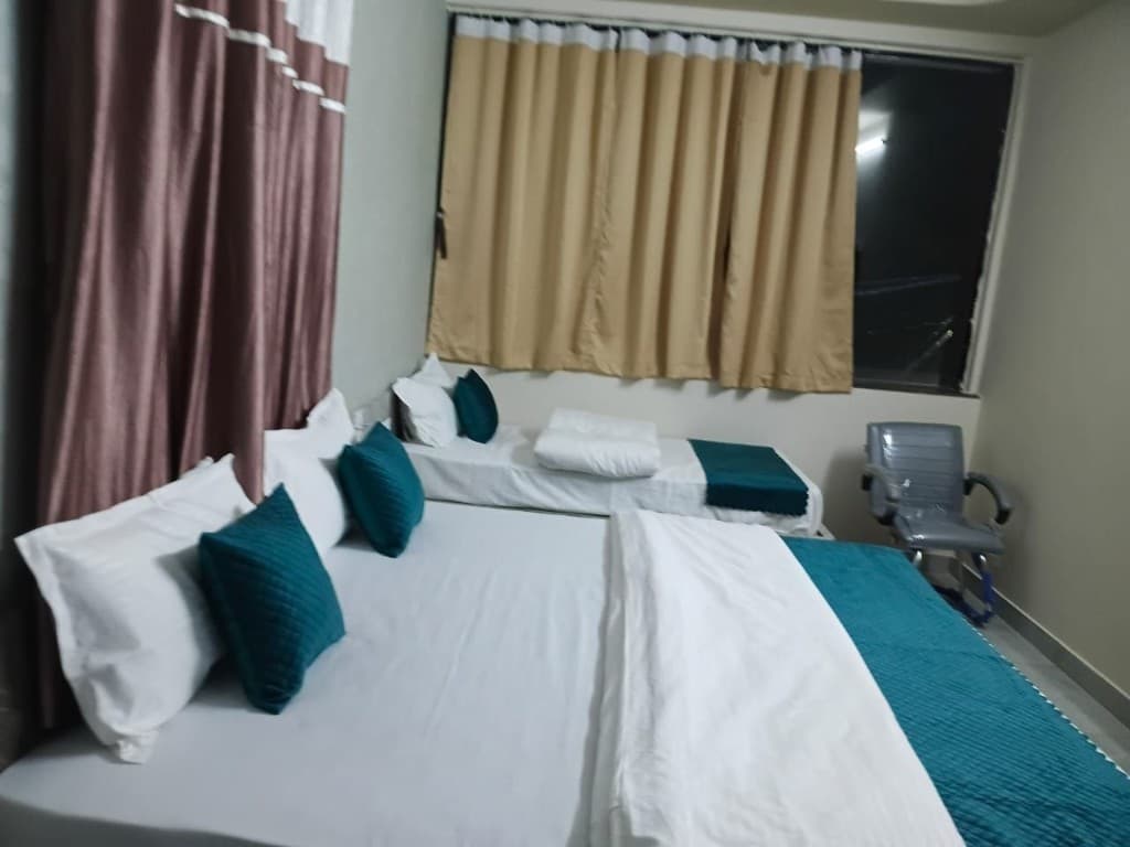Non-AC Room window view, dual curtains, and executive desk chair