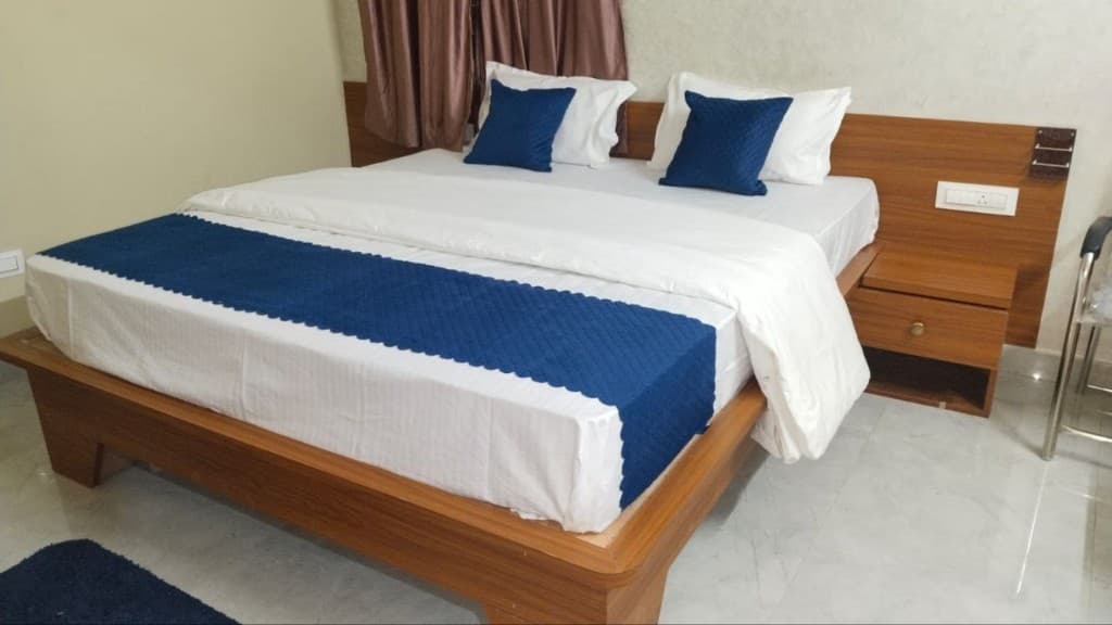Executive Suite king bed angled view with royal blue runner